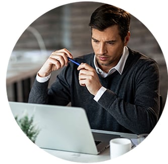 concentrated-businessman-reading-something-computer-while-working-office